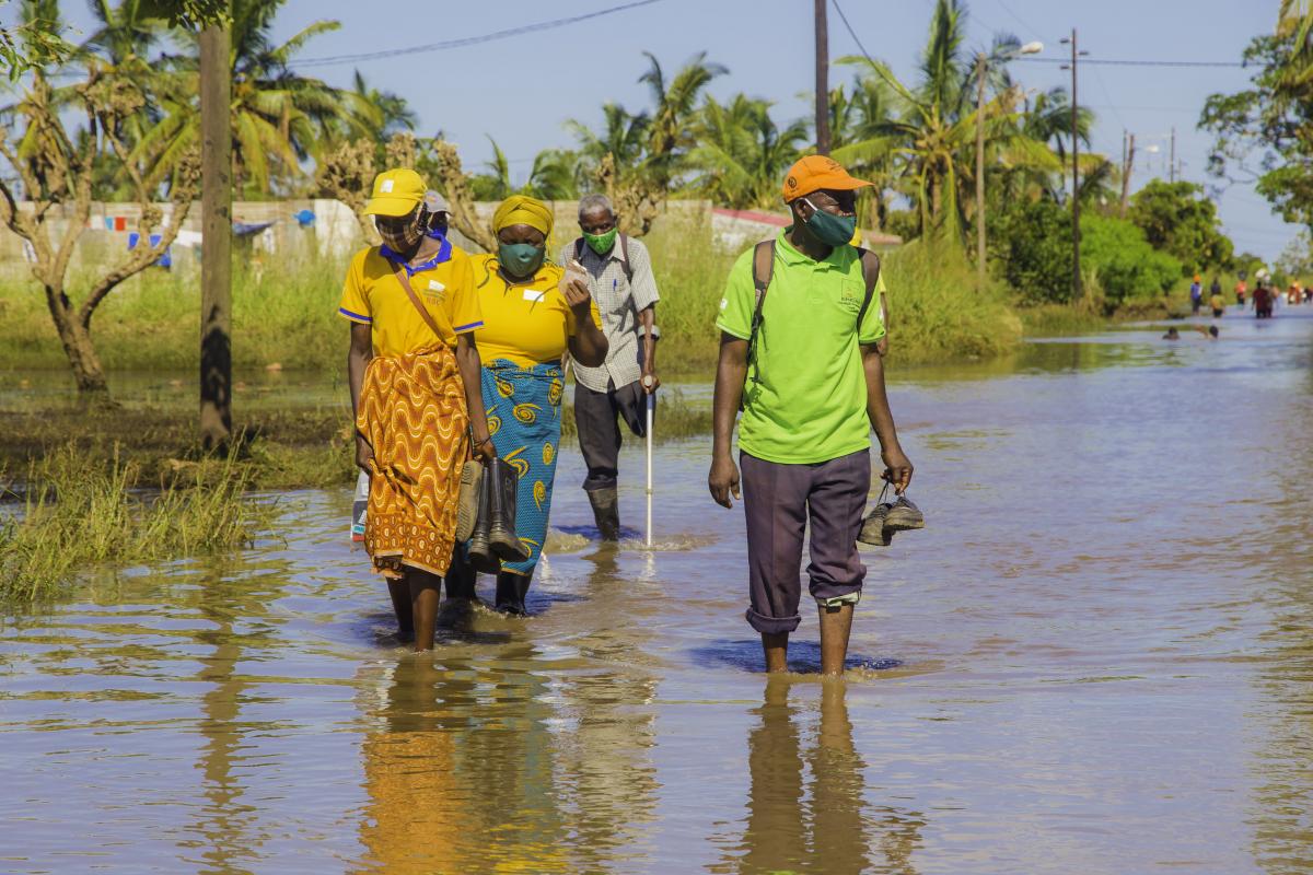 People walk in flooded Buzi after Cyclone Eloise hit